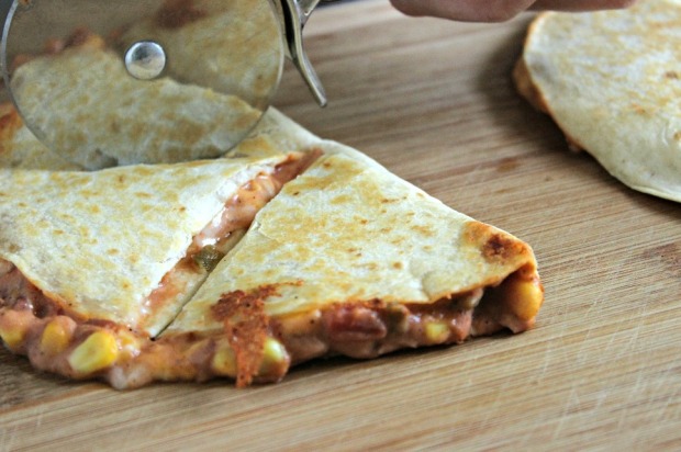 Cutting Cheese and Refried Bean Quesadilla with Pizza Cutter